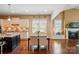 Spacious kitchen and dining area with granite island, stainless appliances, and hardwood floors at 2119 Augusta National Dr, Denver, NC 28037