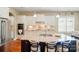 Bright kitchen with granite counters, an island, stainless steel appliances, and white cabinetry at 2119 Augusta National Dr, Denver, NC 28037