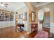 Open-concept living space featuring hardwood floors, built-in shelves, and staircase at 2119 Augusta National Dr, Denver, NC 28037