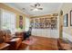 Bright office space with built-in bookshelves, hardwood floors, and a comfortable seating area at 2119 Augusta National Dr, Denver, NC 28037