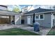 View of the gray home's backyard with concrete patio, lawn, and detached carport at 2124 Roslyn Ave, Charlotte, NC 28208