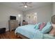 Comfortable bedroom with ceiling fan, hardwood floors, and natural light at 2124 Roslyn Ave, Charlotte, NC 28208