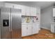 Bright kitchen featuring stainless steel fridge, white cabinets and modern backsplash at 2124 Roslyn Ave, Charlotte, NC 28208