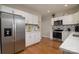 Modern kitchen with white cabinets, stainless steel appliances, and a tiled backsplash, offering a stylish cooking space at 2124 Roslyn Ave, Charlotte, NC 28208