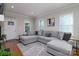 Cozy living room features a large gray sectional, hardwood floors, and neutral walls, creating a welcoming atmosphere at 2124 Roslyn Ave, Charlotte, NC 28208