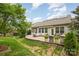 Beautiful backyard showcasing an outdoor patio with furnishings, grill and manicured landscaping at 2158 Winhall Rd, Fort Mill, SC 29715