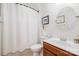 Bathroom features a tub with shower, a sink with wood cabinet, and a round mirror at 2158 Winhall Rd, Fort Mill, SC 29715