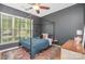 Cozy bedroom with a four-poster bed, patterned rug, ceiling fan, and natural light at 2158 Winhall Rd, Fort Mill, SC 29715