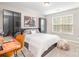 Relaxing bedroom featuring a large bed, desk, and closet with a large window at 2158 Winhall Rd, Fort Mill, SC 29715