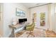 Bright home office features a modern desk, two monitors, and a door leading to the porch at 2158 Winhall Rd, Fort Mill, SC 29715