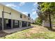 Spacious backyard showing the house exterior, concrete patio, shed, and lush greenery at 221 Belton Ave, Mount Holly, NC 28120