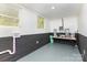 Unfinished basement offers potential with painted block walls, two windows and utility connections at 221 Belton Ave, Mount Holly, NC 28120