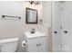 Updated bathroom featuring a modern vanity, framed mirror, toilet, and updated fixtures at 221 Belton Ave, Mount Holly, NC 28120