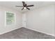 This bedroom has soft gray walls, comfortable carpet, and a ceiling fan at 221 Belton Ave, Mount Holly, NC 28120