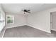 Bright bedroom with sleek gray flooring, complemented by a modern ceiling fan and large window at 221 Belton Ave, Mount Holly, NC 28120