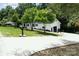 Inviting ranch-style home featuring a long driveway, an attached garage, and a well-manicured lawn at 221 Belton Ave, Mount Holly, NC 28120
