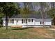 Charming single-story home with white siding, black shutters, and a inviting front porch at 221 Belton Ave, Mount Holly, NC 28120