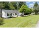 Charming single-story home featuring a well-maintained lawn, modern exterior, and a welcoming front porch at 221 Belton Ave, Mount Holly, NC 28120