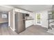This kitchen has stainless appliances, white cabinets, granite countertops, and vinyl floors at 221 Belton Ave, Mount Holly, NC 28120