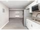 Basement kitchen with stainless appliances, white cabinets, and vinyl plank floors at 221 Belton Ave, Mount Holly, NC 28120