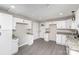 Well-lit kitchen showcasing granite countertops, white cabinets, and modern hardware at 221 Belton Ave, Mount Holly, NC 28120