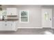 Bright kitchen featuring granite countertops, white cabinetry, and a modern faucet at 221 Belton Ave, Mount Holly, NC 28120