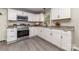 Well-lit kitchen with white cabinets, stainless steel appliances, and granite countertops at 221 Belton Ave, Mount Holly, NC 28120