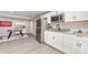 Kitchenette with stainless appliances, granite counters, white cabinets, and a foosball table at 221 Belton Ave, Mount Holly, NC 28120