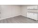 This living area features modern vinyl floors, white cabinets with stone countertops, and neutral walls at 221 Belton Ave, Mount Holly, NC 28120