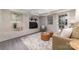 Cozy living room with a brick fireplace, neutral furniture, and stylish decor at 221 Belton Ave, Mount Holly, NC 28120
