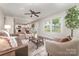 Bright living room featuring modern furniture, neutral tones, hardwood floors, and lots of natural light at 221 Belton Ave, Mount Holly, NC 28120