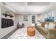 Inviting living room with a brick fireplace, comfortable seating, and backyard access at 221 Belton Ave, Mount Holly, NC 28120