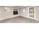 Inviting living room featuring vinyl plank flooring, a brick fireplace, and a glass door at 221 Belton Ave, Mount Holly, NC 28120