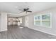Open living space with gray flooring seamlessly connecting the living room and kitchen area at 221 Belton Ave, Mount Holly, NC 28120