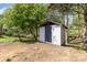Exterior view of storage shed in the backyard provides extra space for gardening equipment and tools at 221 Belton Ave, Mount Holly, NC 28120
