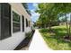 Landscaped side yard featuring a white gravel path, lush greenery, and appealing exterior details at 221 Belton Ave, Mount Holly, NC 28120