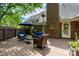 Brick home with a deck and outdoor dining in the backyard with mature trees at 2382 Erika Ln, Gastonia, NC 28056