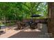 Scenic backyard showcasing lush trees, a wooden fence, deck, and green lawn at 2382 Erika Ln, Gastonia, NC 28056