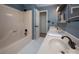 Bathroom showcasing double sinks with dark fixtures, and a shower-tub combo with a door leading to another room at 2382 Erika Ln, Gastonia, NC 28056