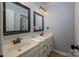 Bathroom with double sinks, light blue walls and matching cabinets at 2382 Erika Ln, Gastonia, NC 28056