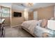 Neutral bedroom featuring a bed with soft pink linens, a TV, and an overhead light with a decorative woven shade at 2382 Erika Ln, Gastonia, NC 28056