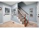 Welcoming entryway featuring a staircase with a wooden handrail, and a front door with side windows for natural light at 2382 Erika Ln, Gastonia, NC 28056