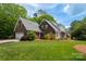 Beautiful brick home featuring an attached garage, manicured lawn, and mature trees at 2382 Erika Ln, Gastonia, NC 28056