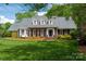 Charming brick home boasts a lush, green lawn and well-maintained landscaping under a bright, sunny sky at 2382 Erika Ln, Gastonia, NC 28056