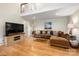 Spacious living room showcases hardwood floors, a large sofa, and a loft overlooking the area at 2382 Erika Ln, Gastonia, NC 28056