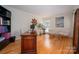 Well-lit home office with hardwood floors, a large desk, and comfortable seating area at 2382 Erika Ln, Gastonia, NC 28056