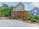 Rear exterior showing a brick house, paved driveway and garden at 2400 Commonwealth Ave, Charlotte, NC 28205