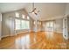 Bright bedroom with hardwood floors, neutral walls, and French doors to a balcony at 2400 Commonwealth Ave, Charlotte, NC 28205