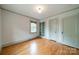 Well-lit bedroom featuring hardwood floors, a built-in bookcase and neutral decor at 2400 Commonwealth Ave, Charlotte, NC 28205