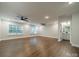Large bonus room with hardwood floors, neutral walls, ceiling fans, and an en-suite bathroom at 2400 Commonwealth Ave, Charlotte, NC 28205